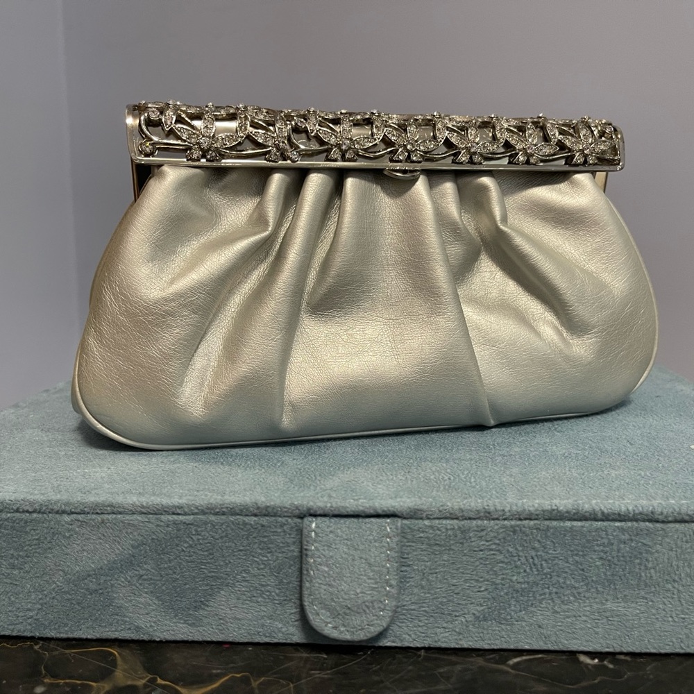 Silver vegan leather evening purse with chain shoulder strap.
